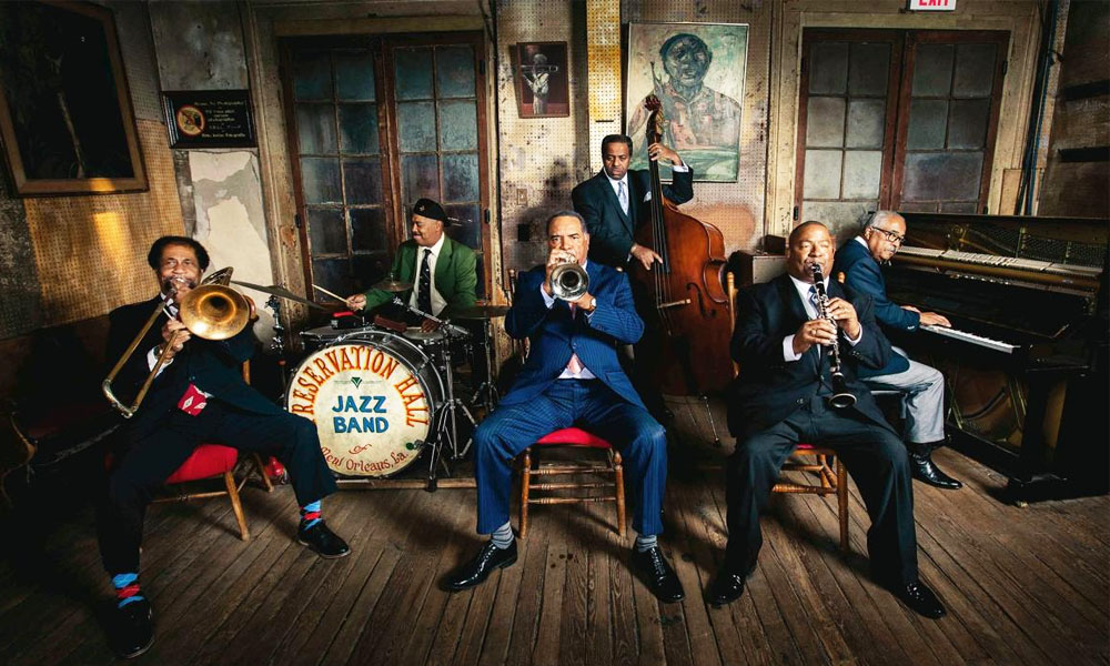 Live performance in the heart of the New Orleans jazz scene with brass band musicians and local crowd